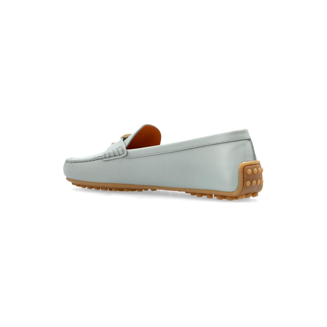 Light blue Tod's City Gommino leather loafers with gold-tone hardware, flat sole, and round toe, slip-on style, side view.
