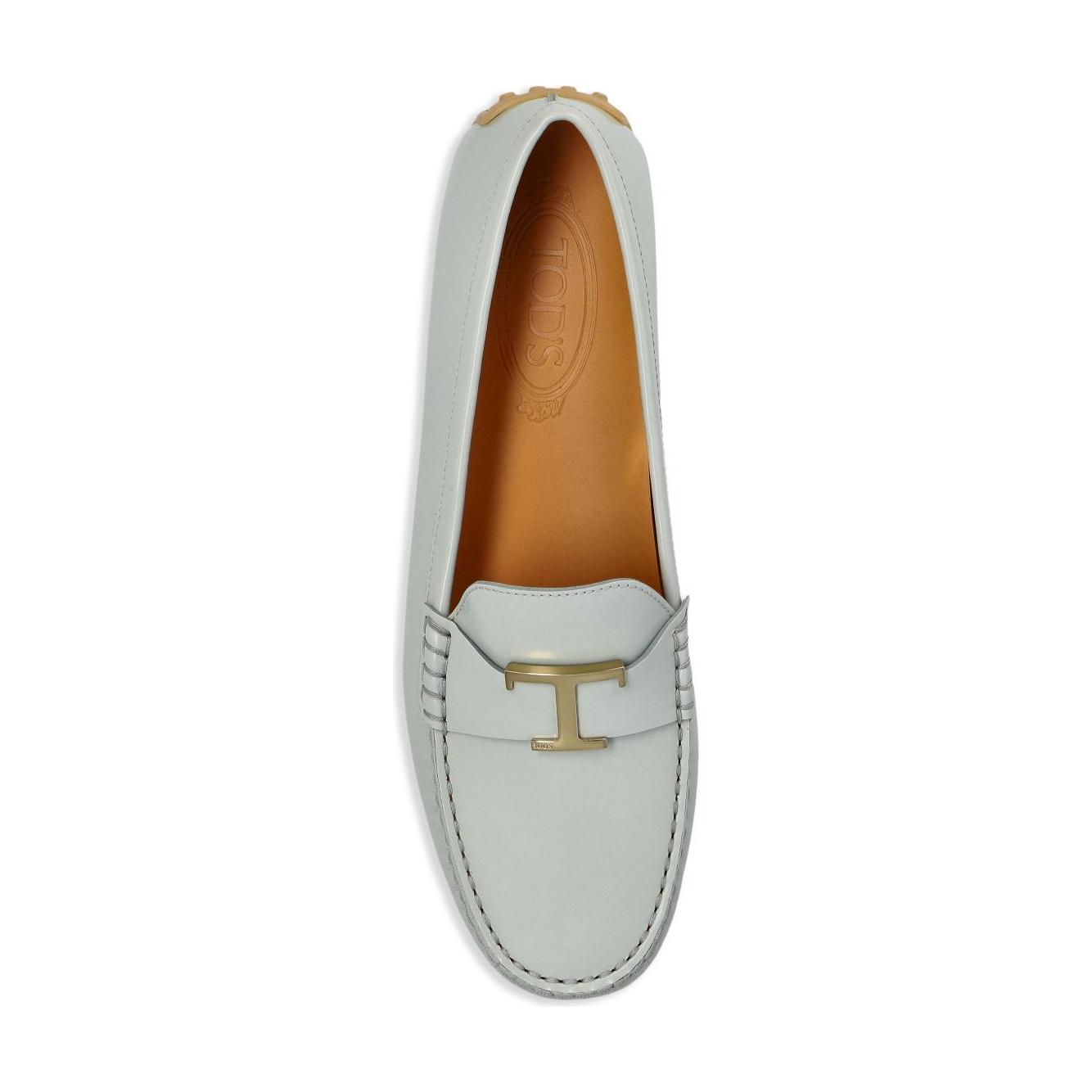 Tod's City Gommino leather loafers in light blue with gold-tone hardware and flat sole, featuring a round toe and slip-on style.