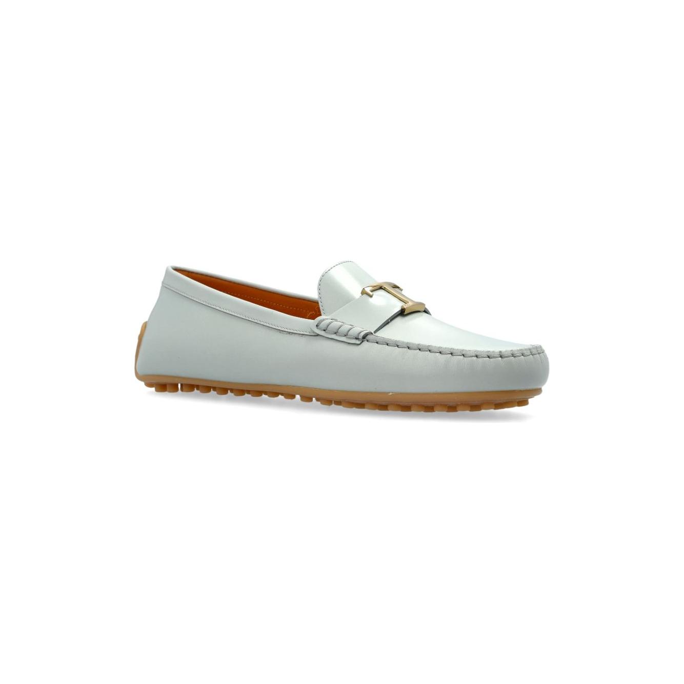Tod's City Gommino grey leather loafers with gold-tone hardware, light blue flat sole, and round toe slip-on design.