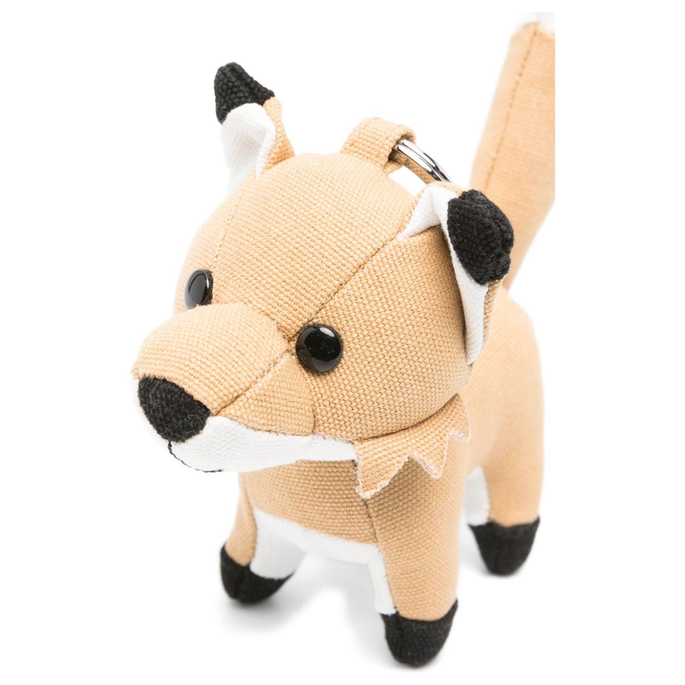 Maison Kitsune beige fox keyring charm with pop-up ears and engraved logo, featuring signature fox motif, perfect accessory addition.