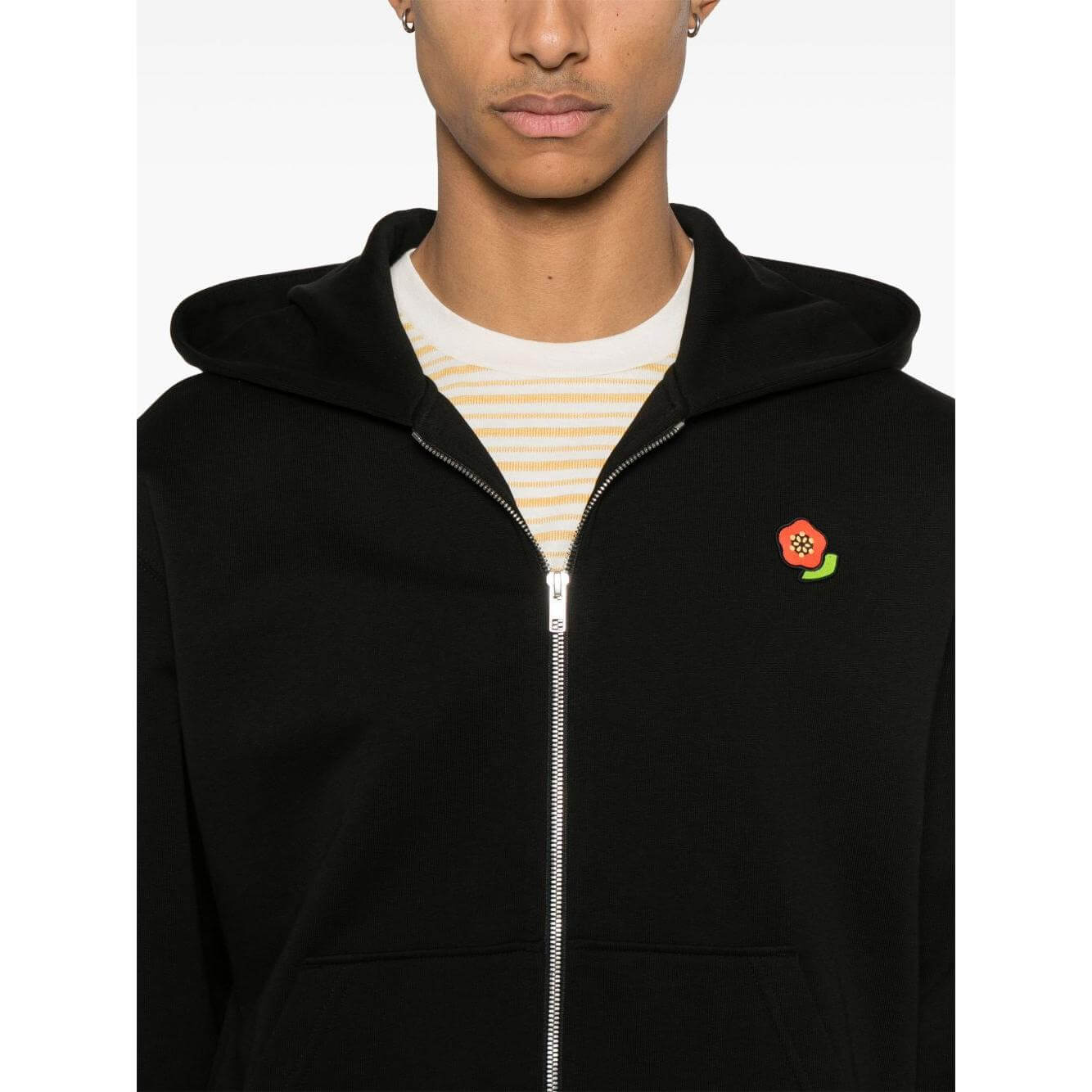 Black Kenzo sweater with front zip, ribbed cuffs, Boke Flower motif, and pouch pockets; model wearing size M.