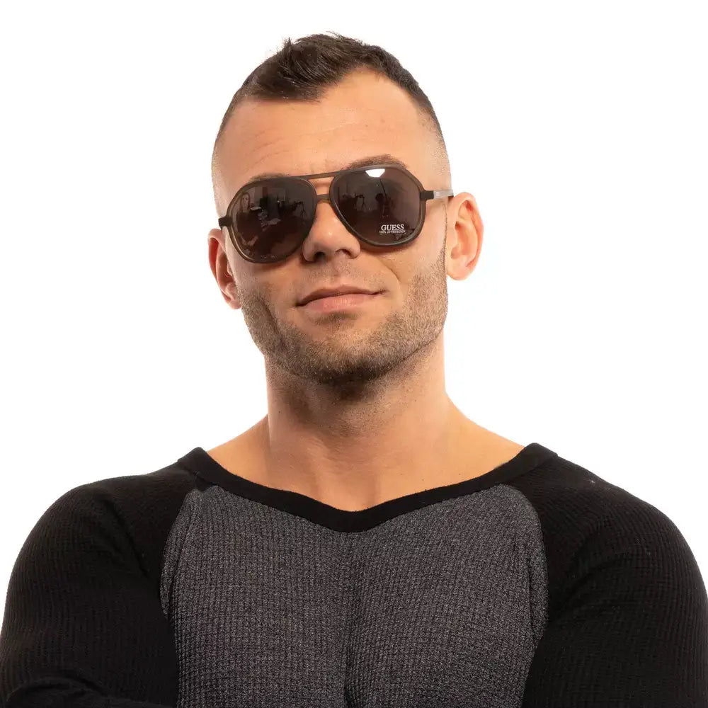 Guess men's aviator sunglasses in brown with plastic frame and mirrored lenses, offering 100% UVA & UVB protection.