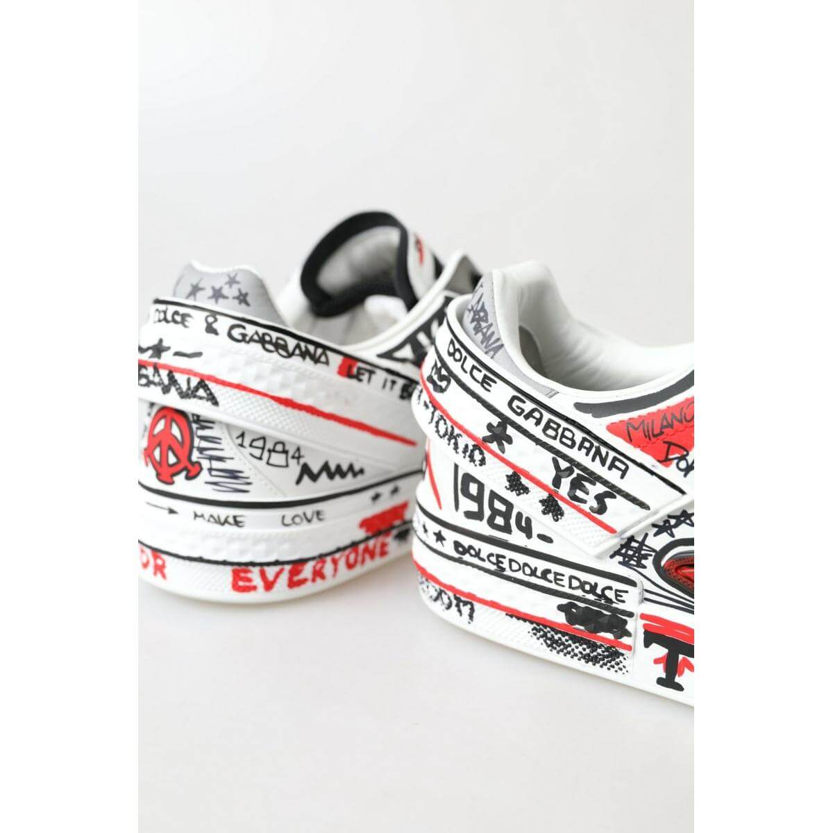 Dolce & Gabbana multicolor hand-painted leather sneakers with artistic designs, showcasing Italian craftsmanship, side and back view.