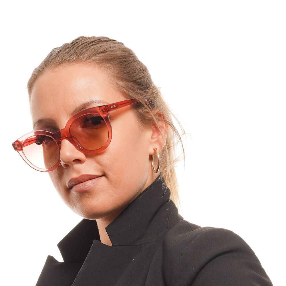 Woman wearing Bally Red Women Sunglasses with red acetate frame and burgundy gradient lenses, stylish round full-rim design.