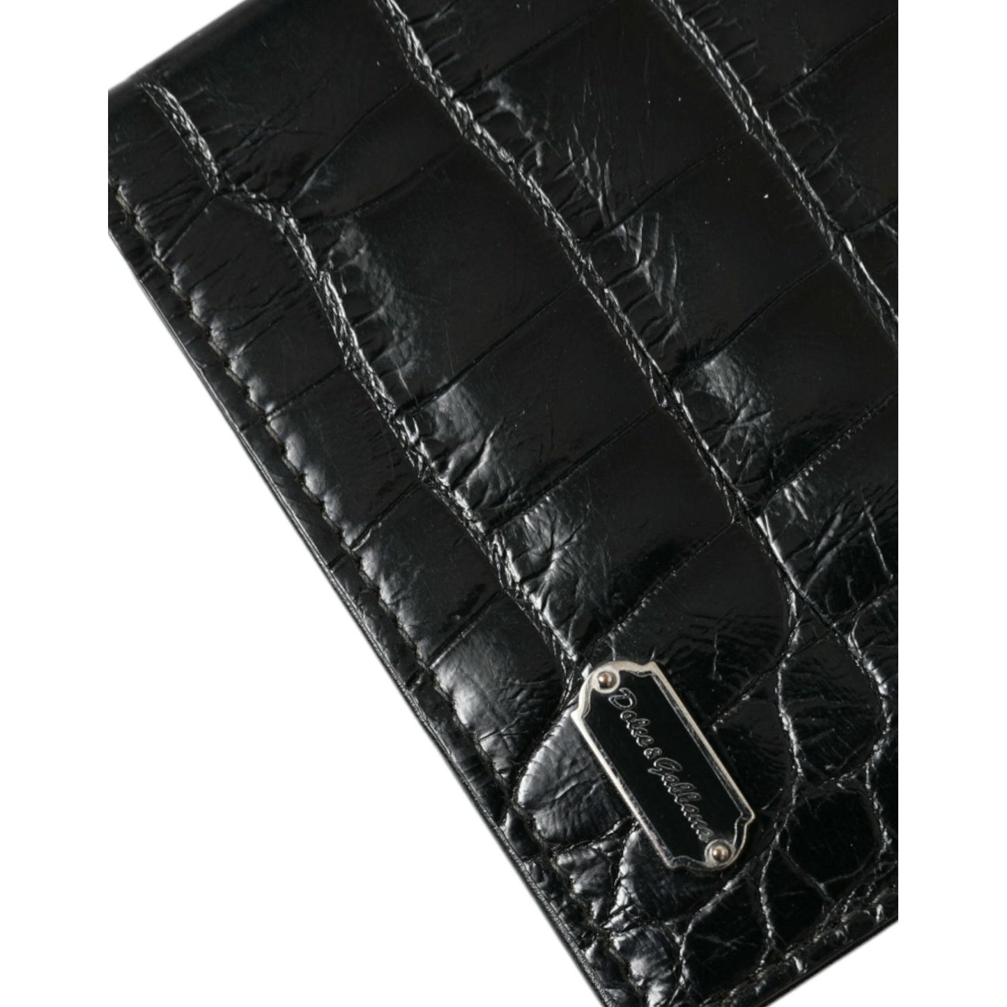 Dolce & Gabbana black exotic skin bifold passport holder with logo plaque, crafted from crocodile and calf leather.