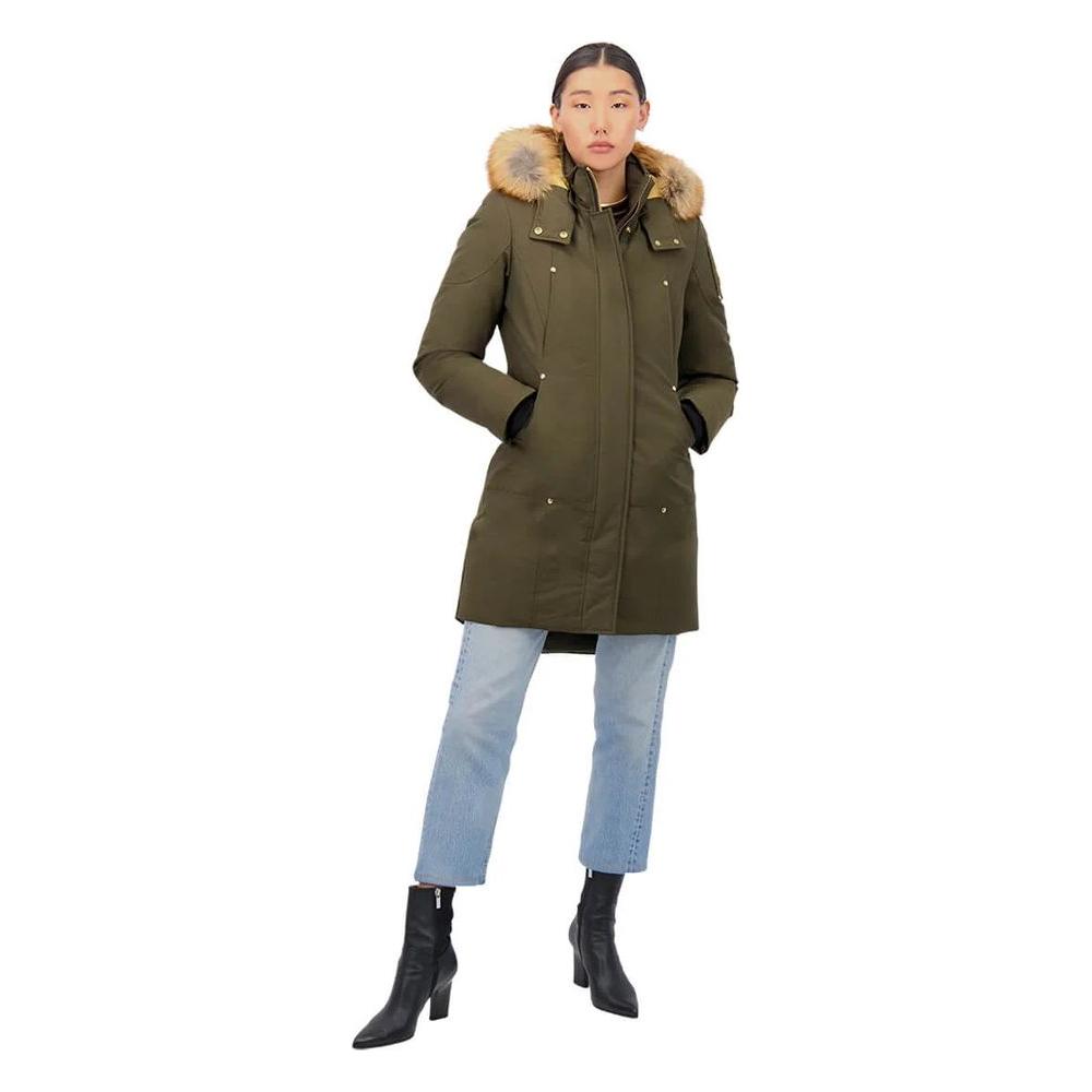 Woman wearing Moose Knuckles Army Cotton Coat, luxurious Gold Stirling Parka with gold-tone hardware and detachable hood, styled with jeans.