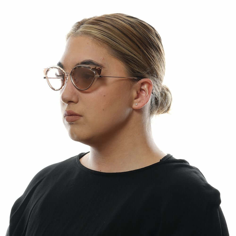 Woman wearing Dsquared² brown cat eye sunglasses with mirrored lenses and a full-rim frame, side view.