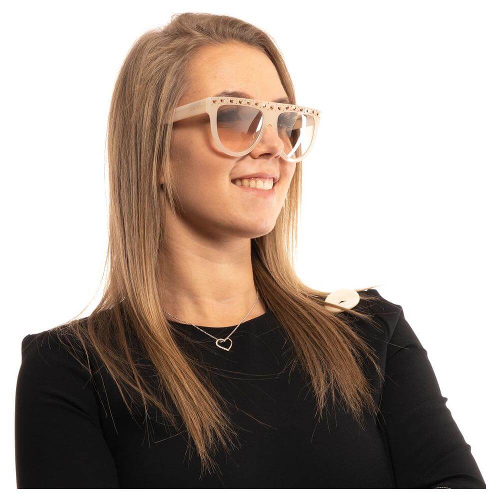Woman wearing Marciano by Guess white round sunglasses with brown gradient lenses, 100% UVA & UVB protection, plastic frame.