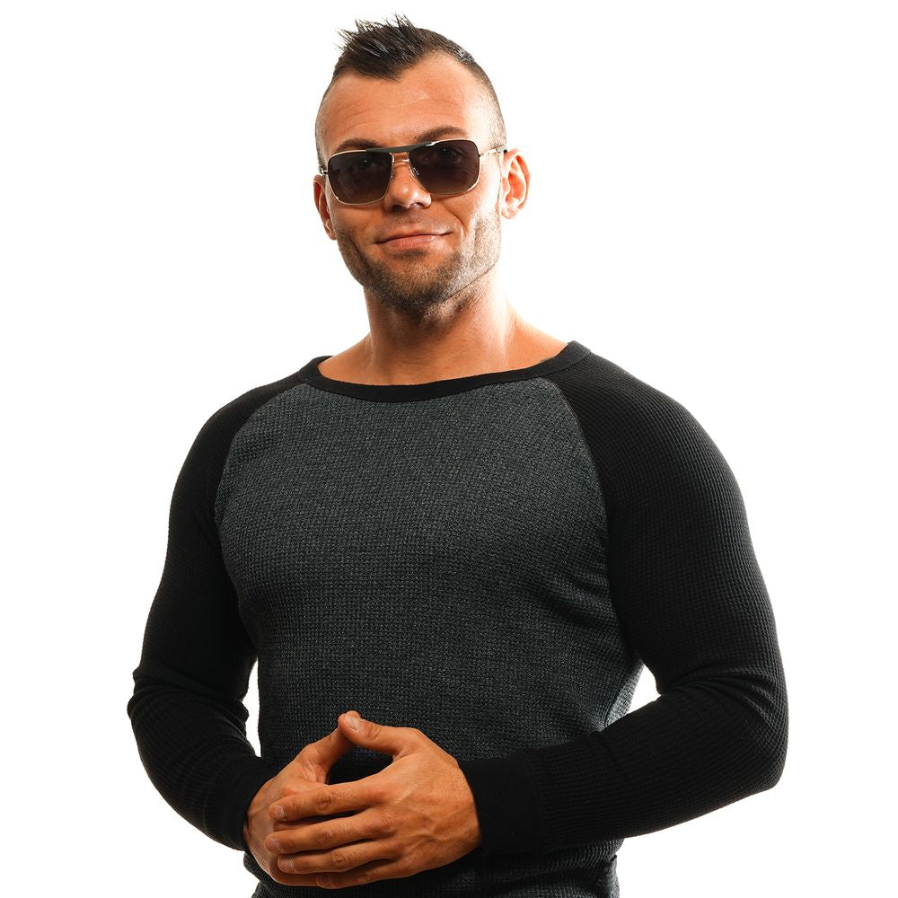 Man wearing gold rectangle sunglasses with green gradient lenses and black sweater, showcasing full-rim metal frame style.