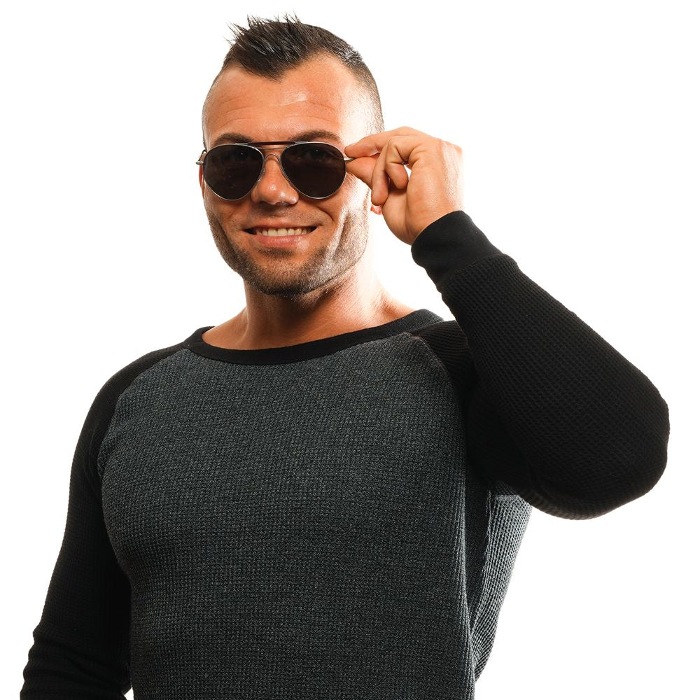 Man wearing Ermenegildo Zegna gold aviator sunglasses with grey lenses, smiling; comfortable long-sleeve shirt, posing against white backdrop.