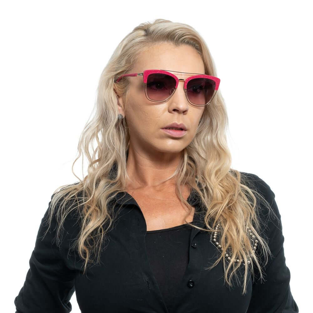 Woman wearing Police Pink Women Sunglasses with pink frame and gradient brown lenses, stylish butterfly design, offering 100% UVA & UVB protection.