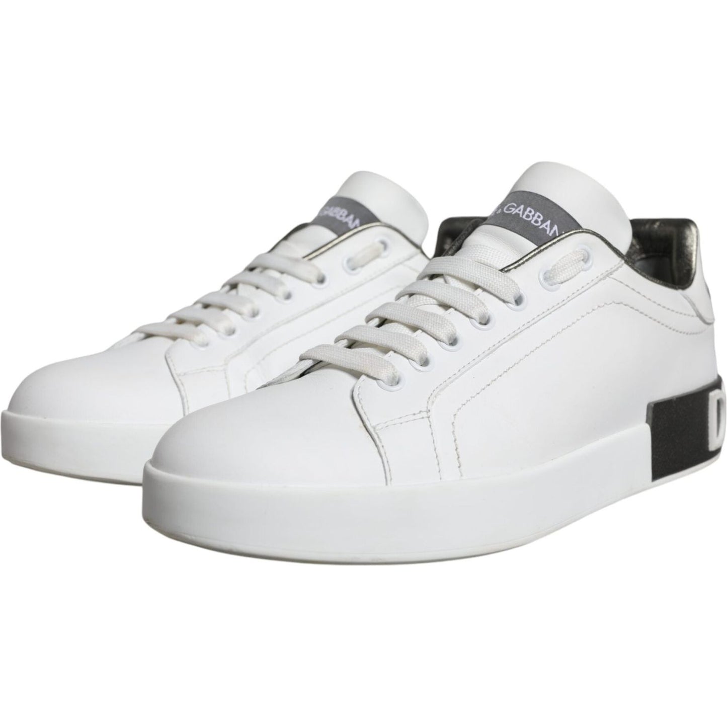 Dolce & Gabbana white leather Portofino low top sneakers with rubber sole and lace-up closure. Made in Italy, preowned with missing logo on left shoe.