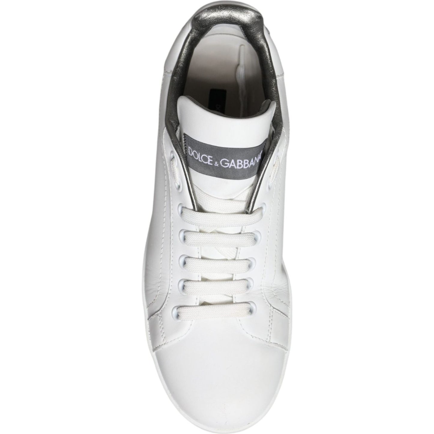 Top view of Dolce & Gabbana white leather Portofino sneakers with lace-up closure and logo detail on tongue, made in Italy.