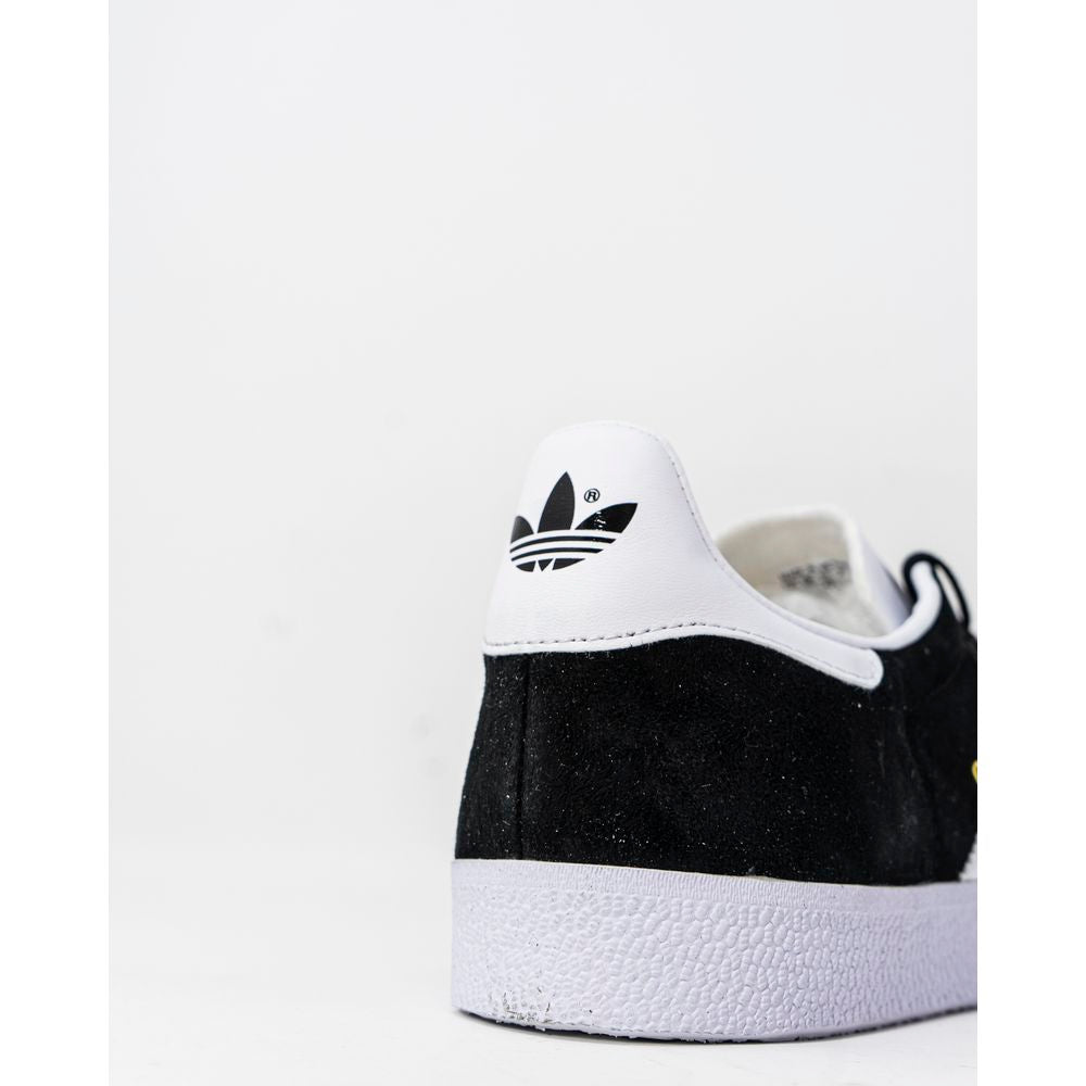 Back view of Adidas Gazelle BB5476 black and white sneakers with iconic logo and rubber sole.