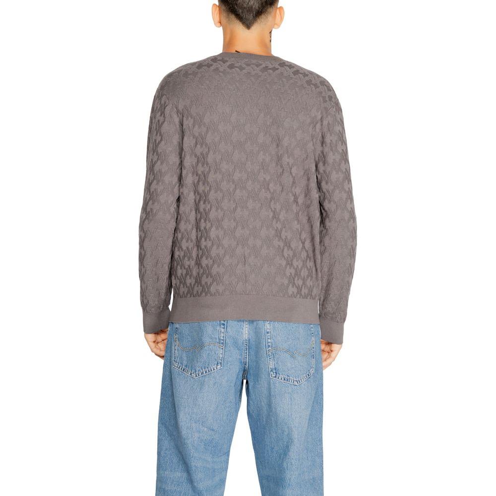 Back view of man wearing Armani Exchange gray viscose knit t-shirt, part of men's fall/winter collection, paired with blue jeans.