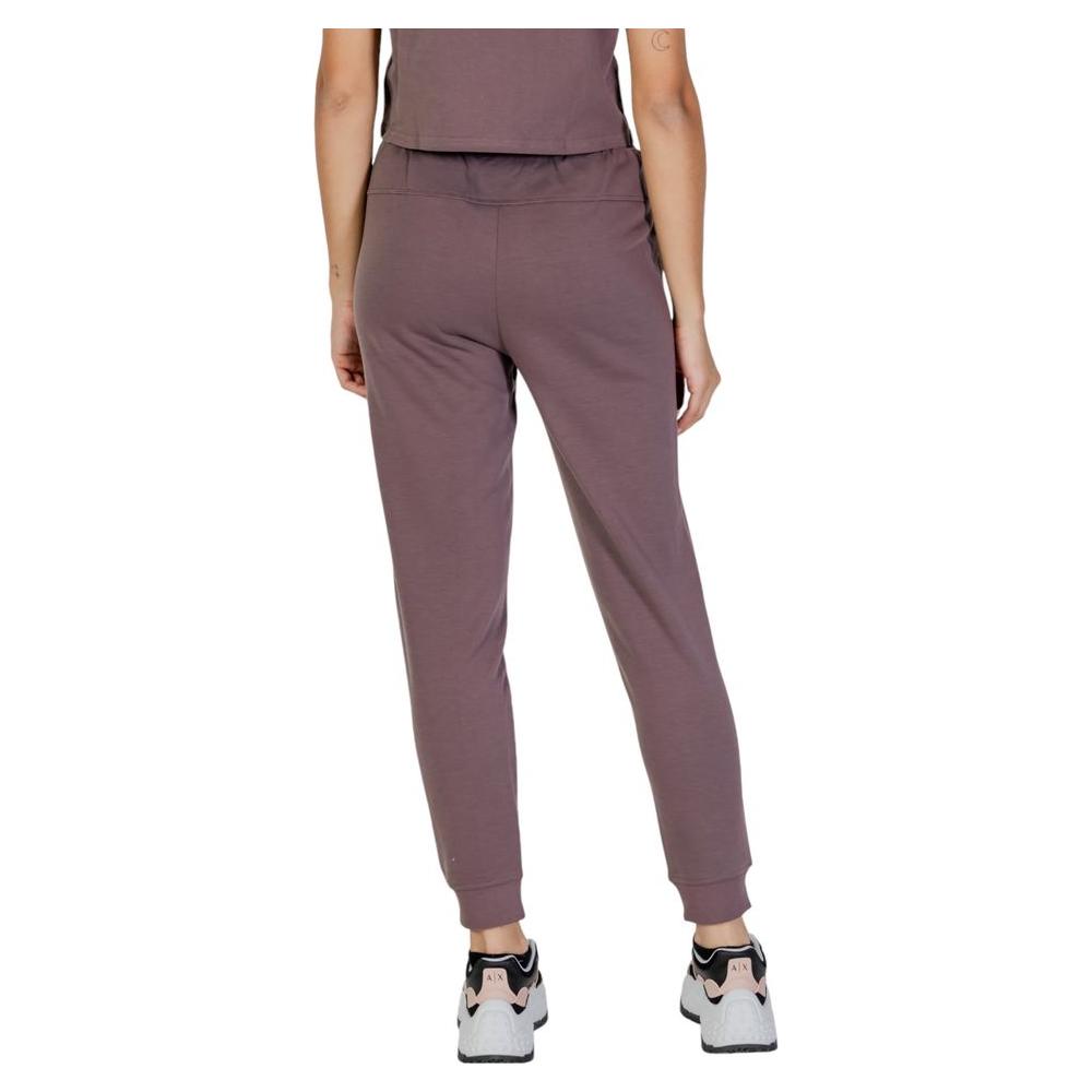 Back view of woman wearing Calvin Klein Sport purple recycled polyester joggers, showcasing fit and style.