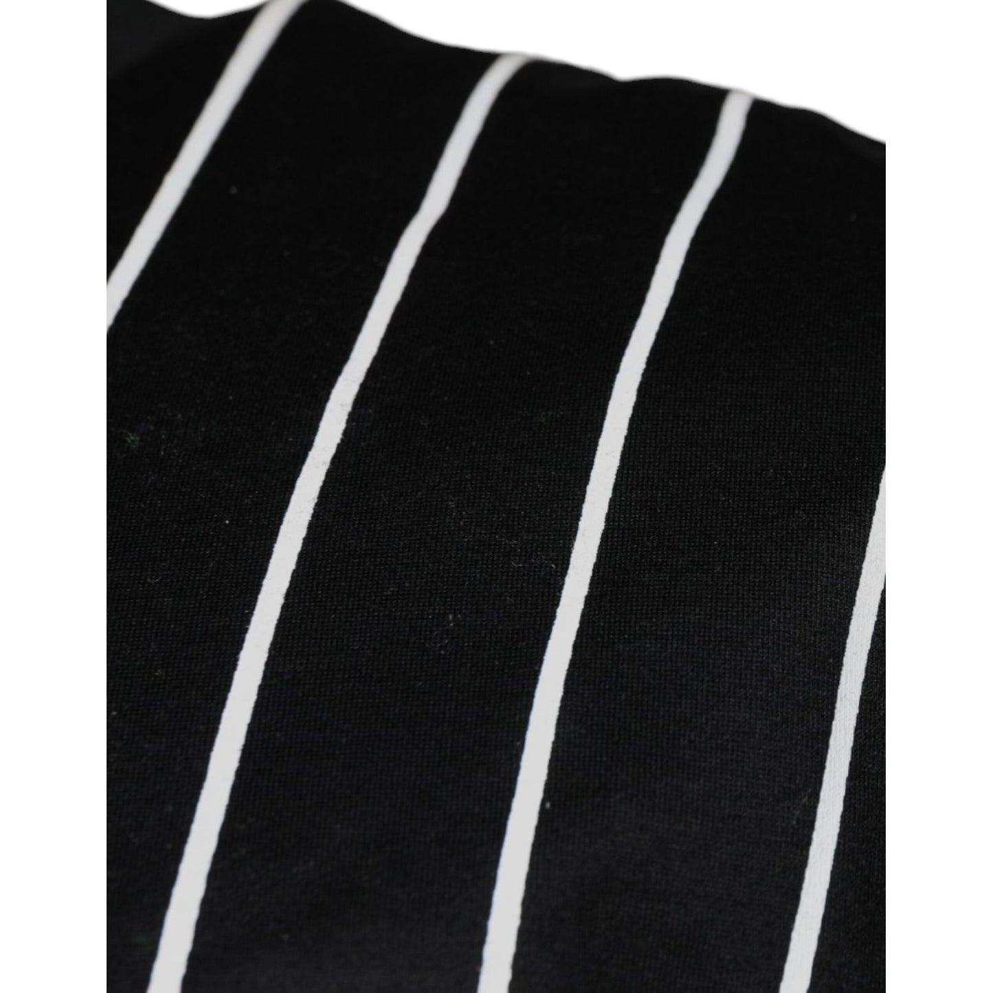 Close-up of Dolce & Gabbana black t-shirt with white polka dot print, showing minor discoloration on cotton fabric.