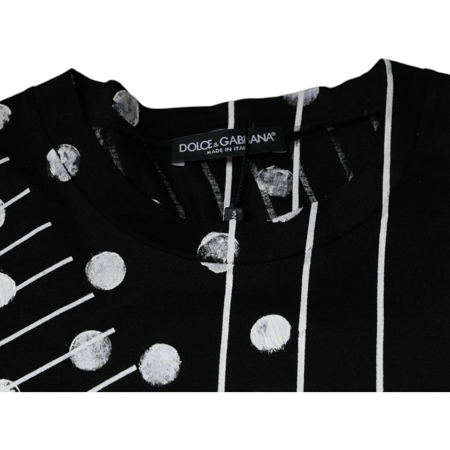 Dolce & Gabbana black cotton polka dot round neck t-shirt with logo, minor print discolorations, made in Italy. Close-up view.
