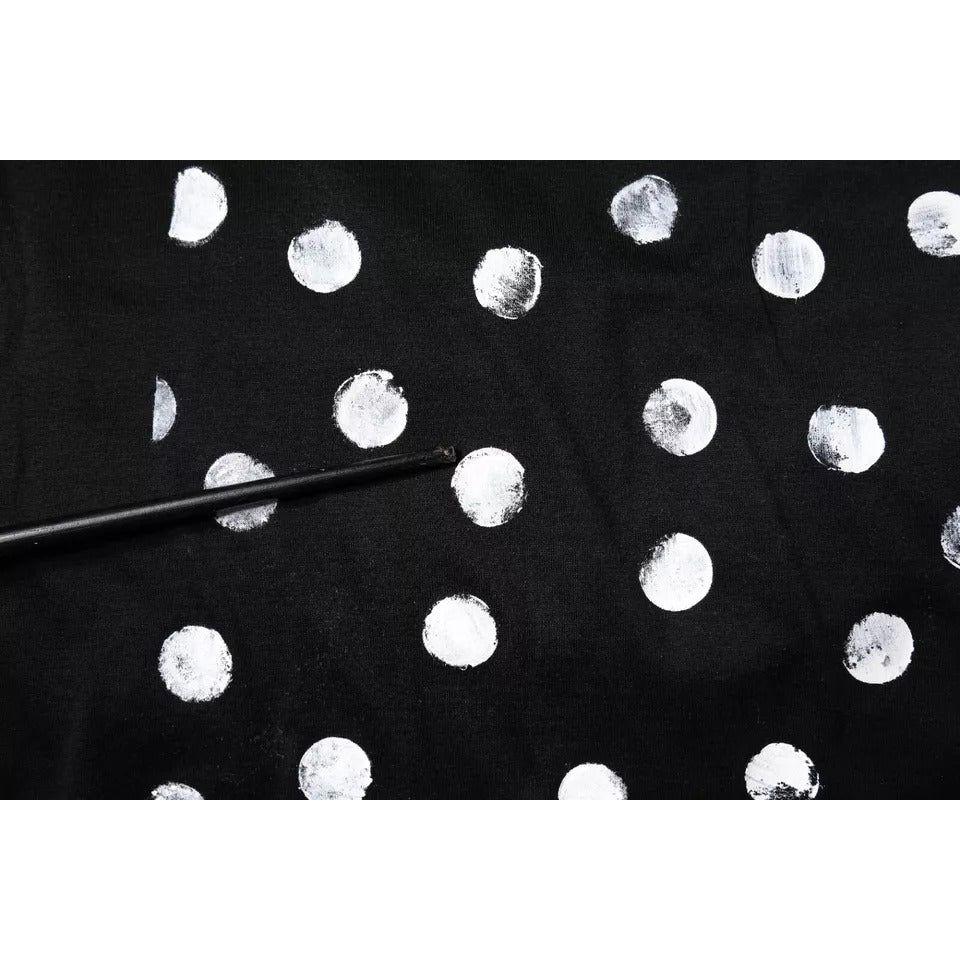 Close-up of Dolce & Gabbana black polka dot t-shirt showing minor print discoloration.