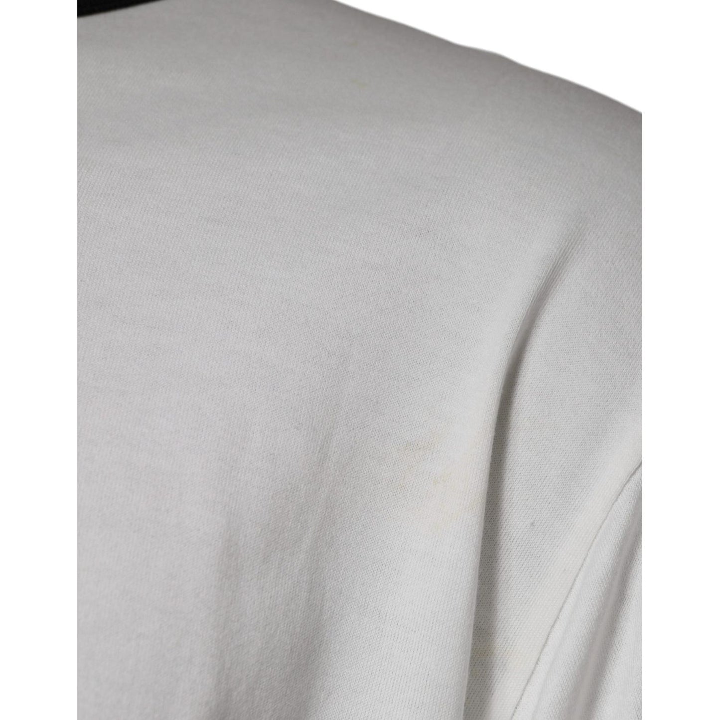 Close-up of minor defect on white Dolce & Gabbana camouflage cotton t-shirt, showing faint marks on fabric.