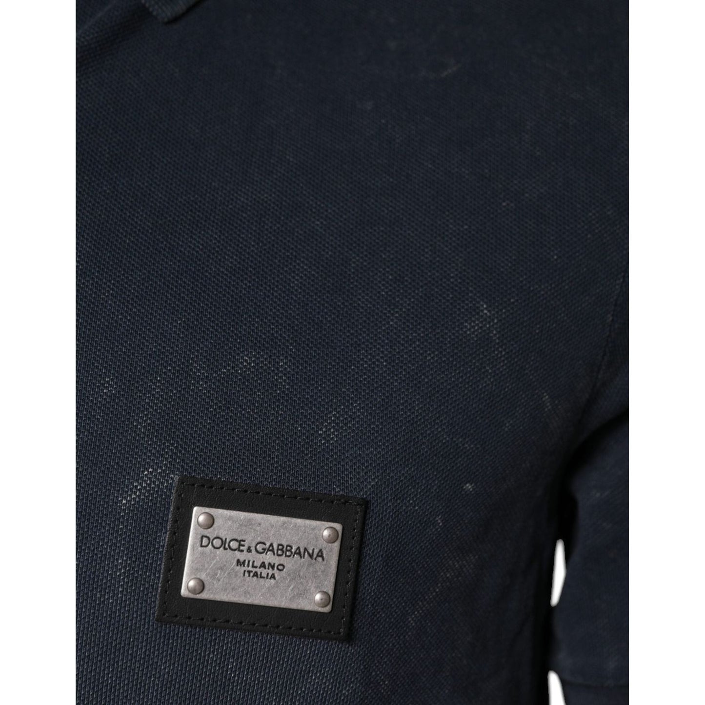 Dolce & Gabbana dark blue polo shirt with logo patch, short sleeves, collared neck, button closure, and repaired holes on the back.