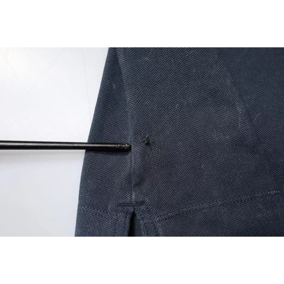 Detailed view of repaired holes on dark blue Dolce & Gabbana polo shirt showing fabric texture and stitching close-up.