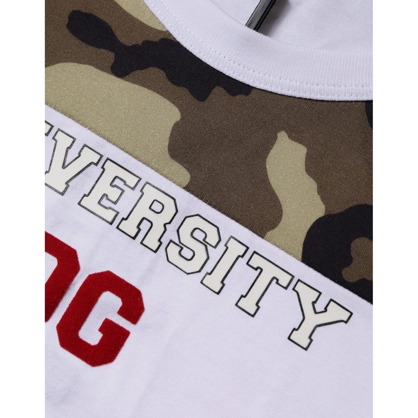 Close-up of Dolce & Gabbana White Camouflage Tank T-shirt with round neck, featuring text and logo details. Minor stains visible on fabric.