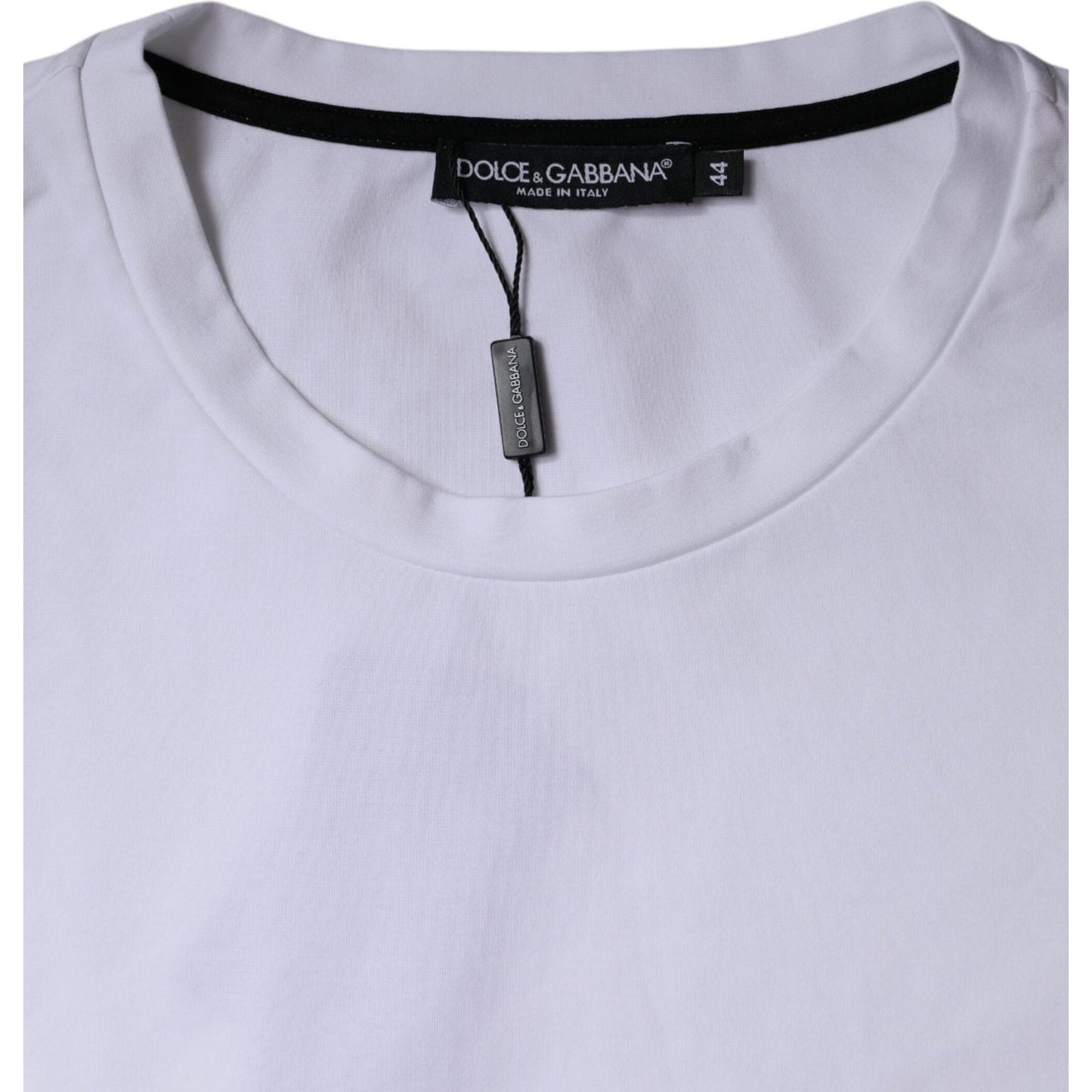 Close up of Dolce & Gabbana white t-shirt, crew neck, label visible, made in Italy, highlighting fabric texture and craftsmanship.