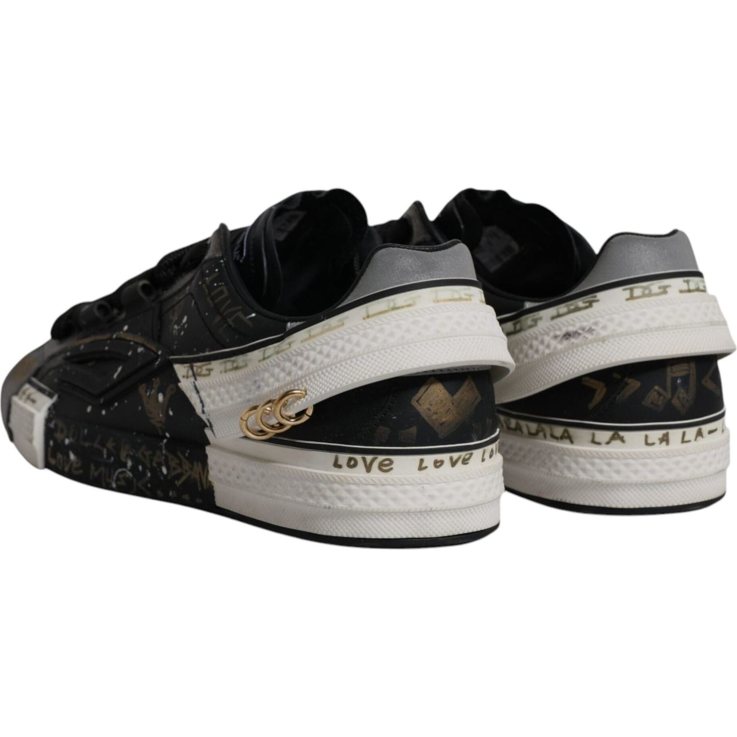 Dolce & Gabbana black and white Portofino low-top sneakers with logo details and rubber sole, rear view. Preowned with discolorations.