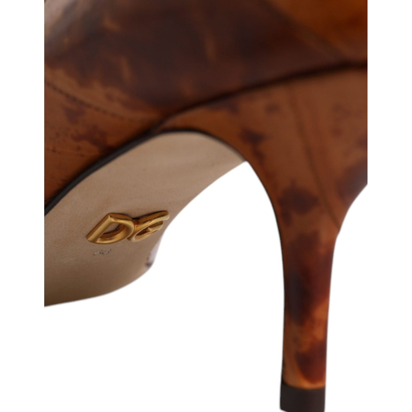 Close-up of Dolce & Gabbana brown leather kitten heels with logo detail, showing minor discoloration. Eel leather, made in Italy, high quality.