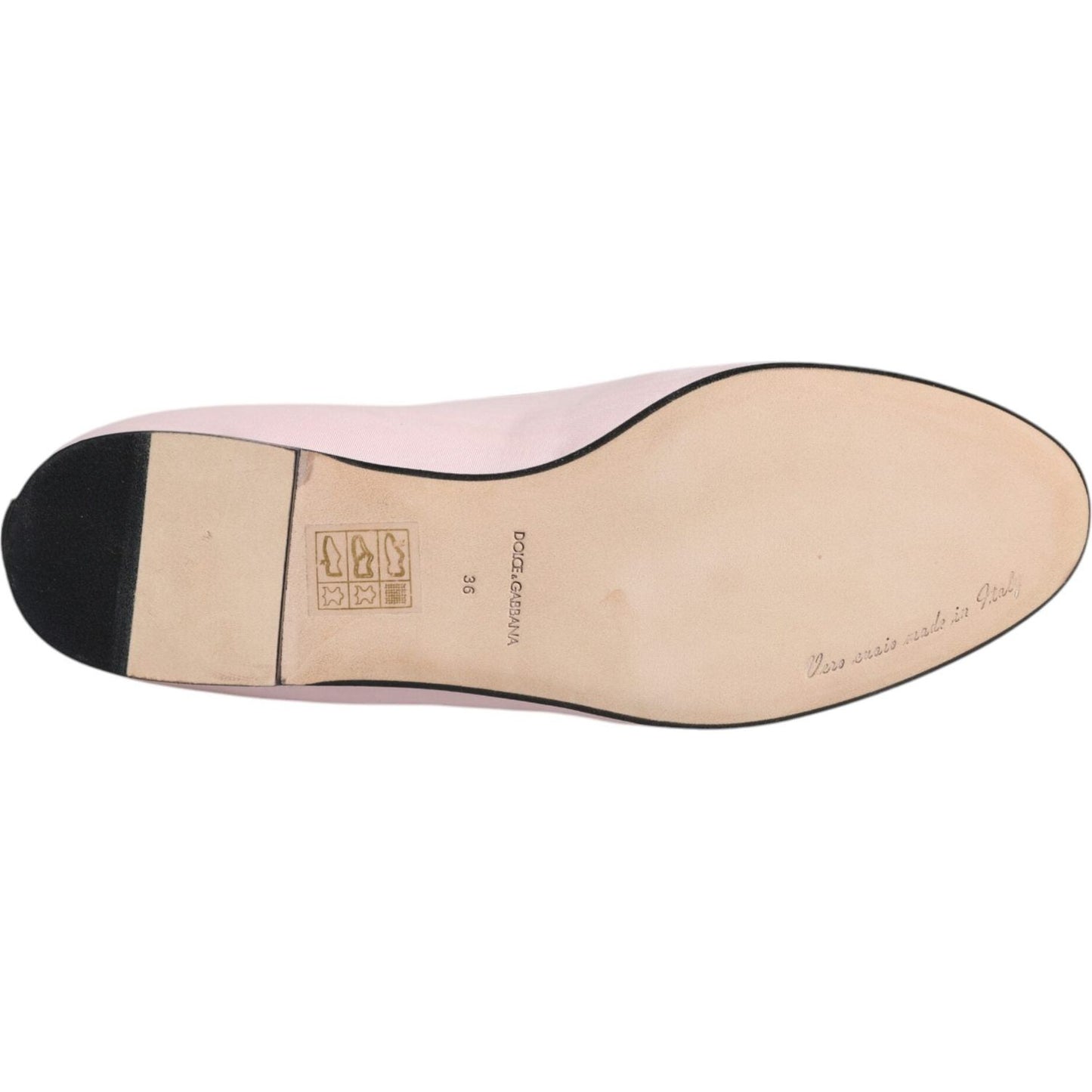 Sole view of Dolce & Gabbana light pink velvet loafers, featuring leather sole and brand details.