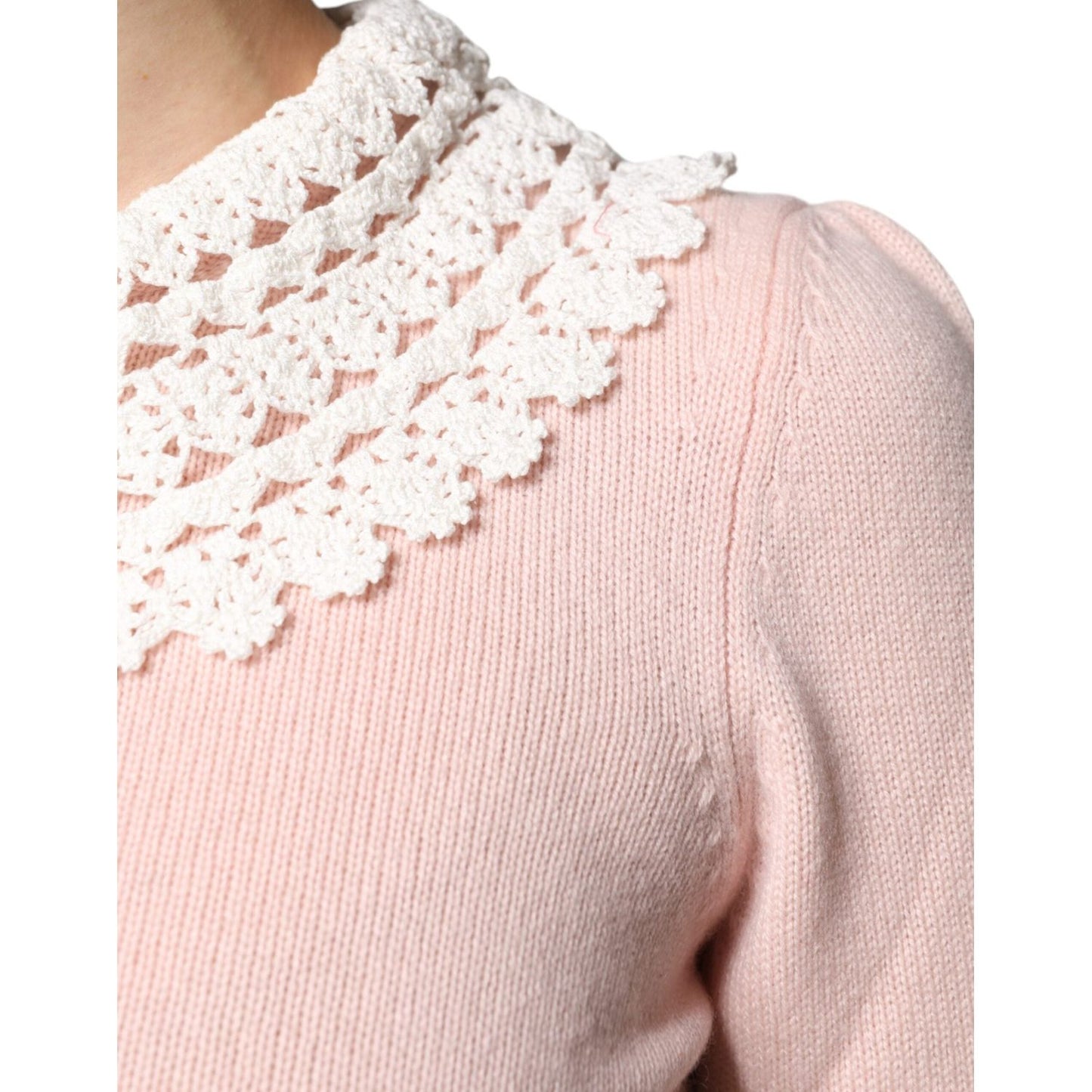 Close-up of Dolce & Gabbana pink cashmere top with a lace collar showing intricate knit details.
