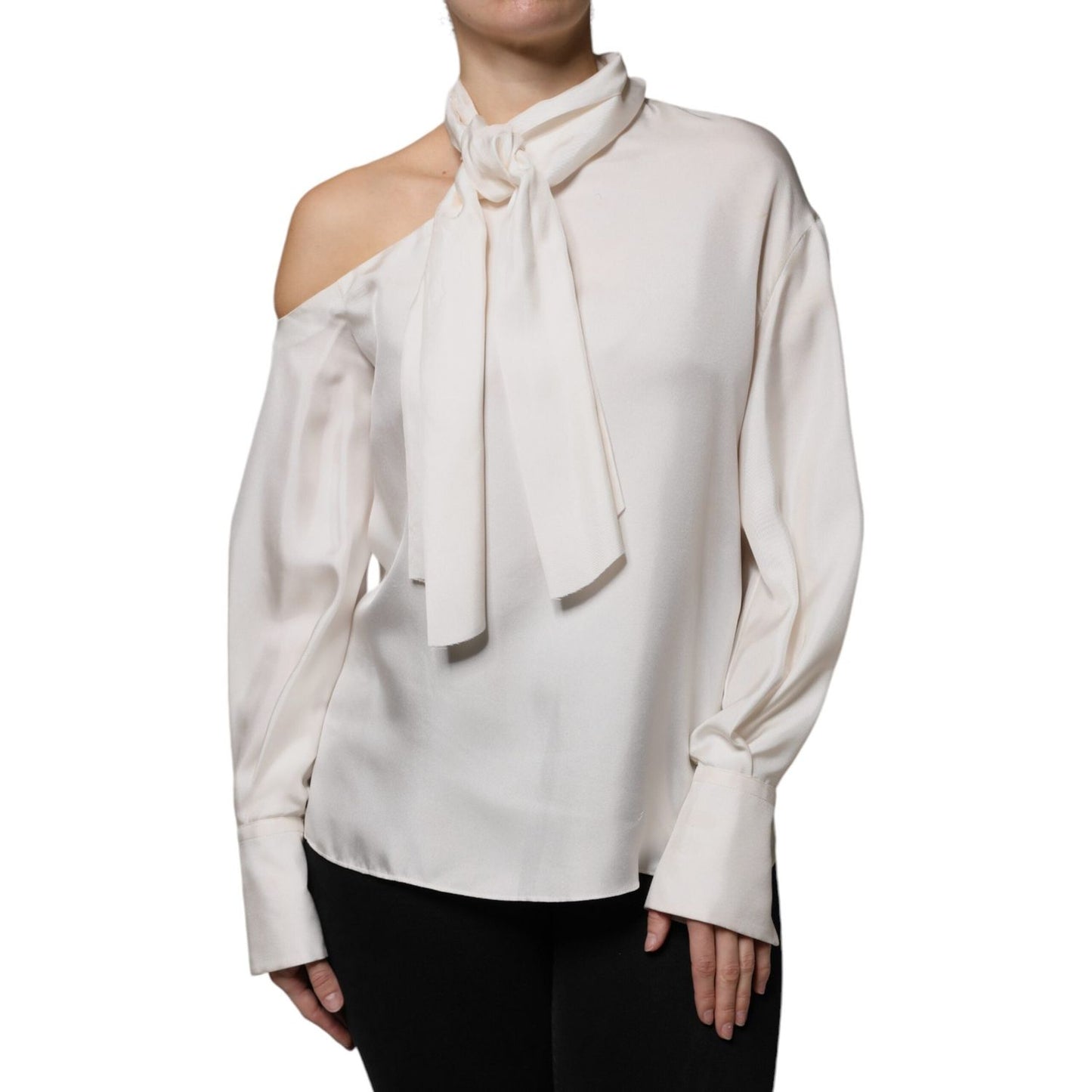 Brunello Cucinelli beige silk top with ascot collar, long sleeves, and buttoned cuffs. Minor defects include pulled threads and makeup stains.