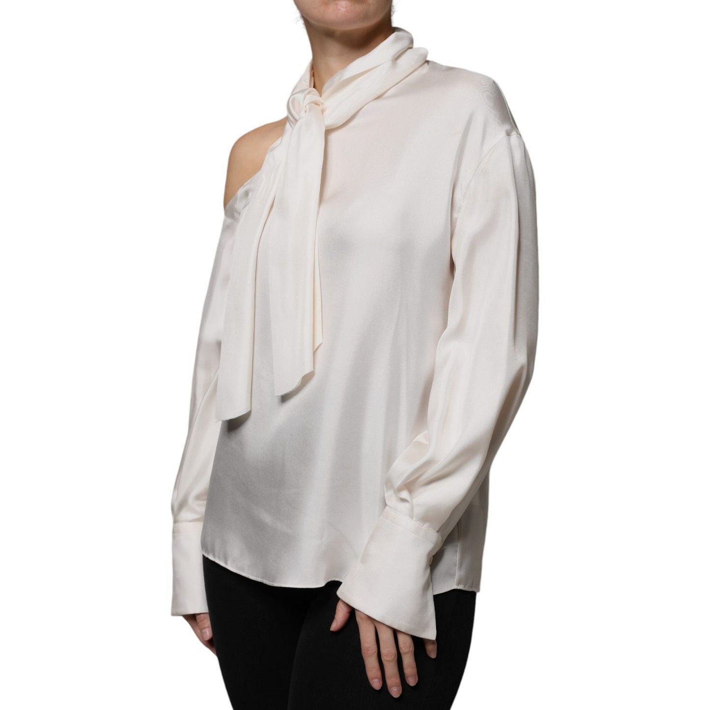 Brunello Cucinelli beige silk top with ascot collar and long sleeves, featuring buttoned cuffs and appliqués.