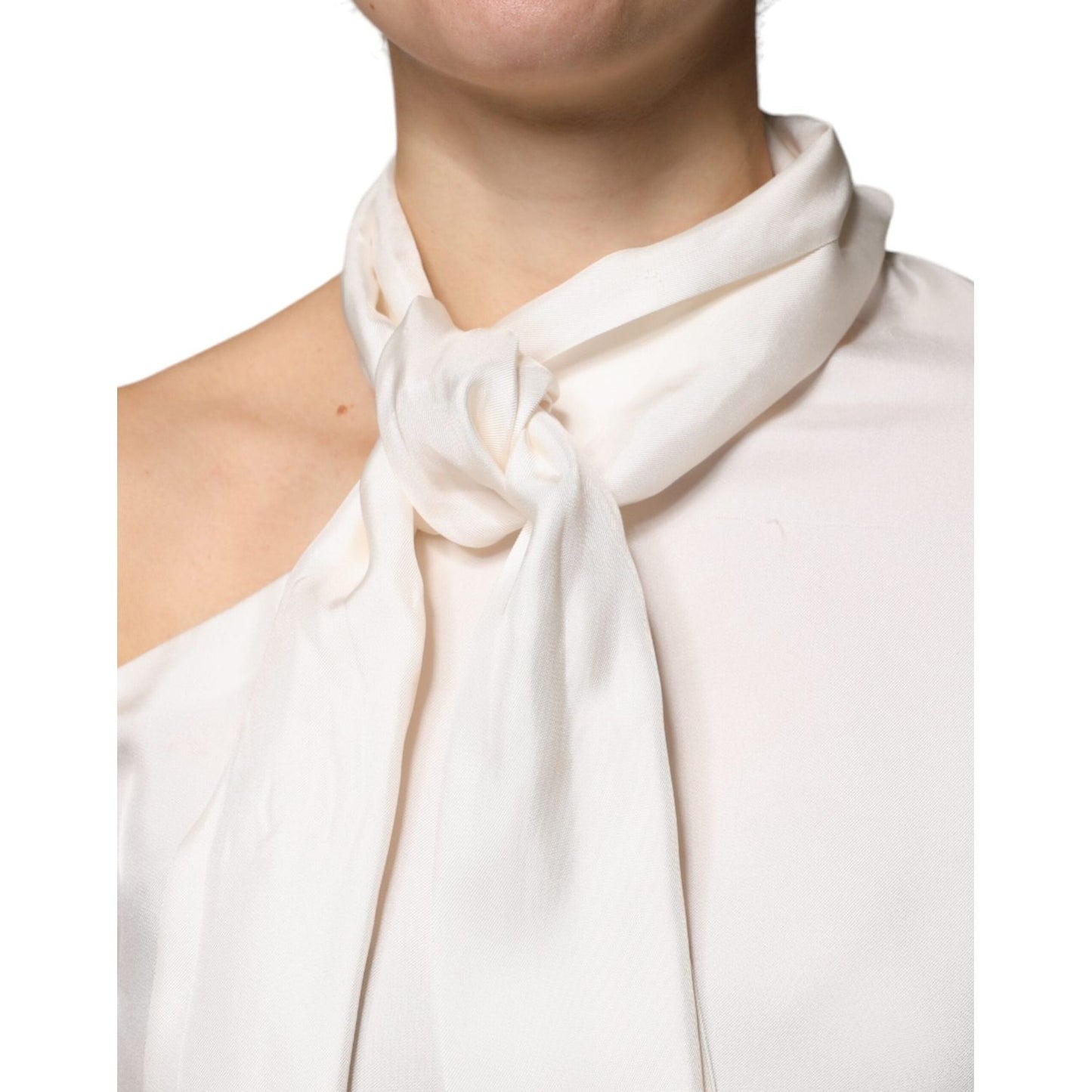 Brunello Cucinelli beige silk ascot collared top with long sleeves, showing detailed tie knot design.