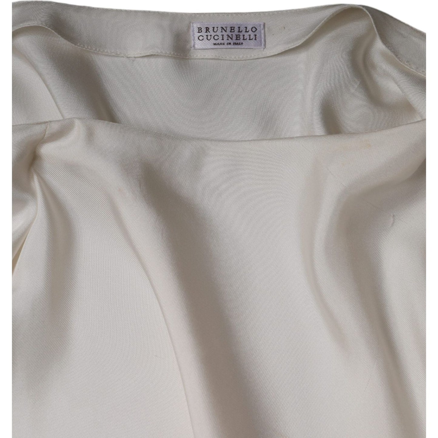 Brunello Cucinelli beige silk top with collared neck and long sleeves, featuring minor defects like pulled threads and makeup stains.