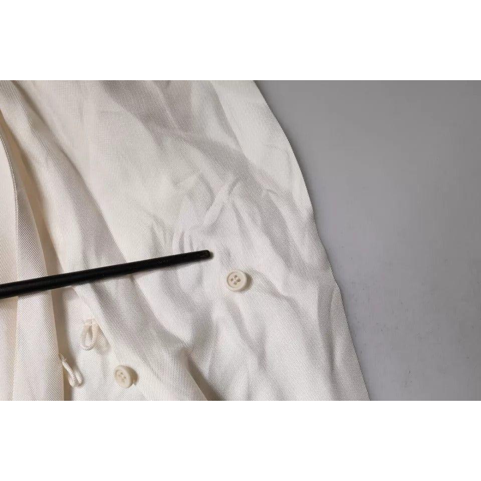 Close-up of Brunello Cucinelli beige silk top showing button details and fabric pulled threads defect.