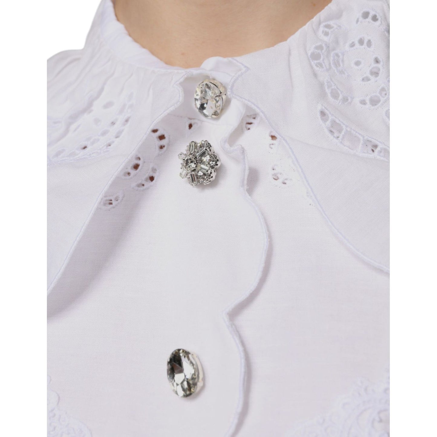 Close-up of Dolce & Gabbana white cotton lace trim blouse collar with crystal button details.