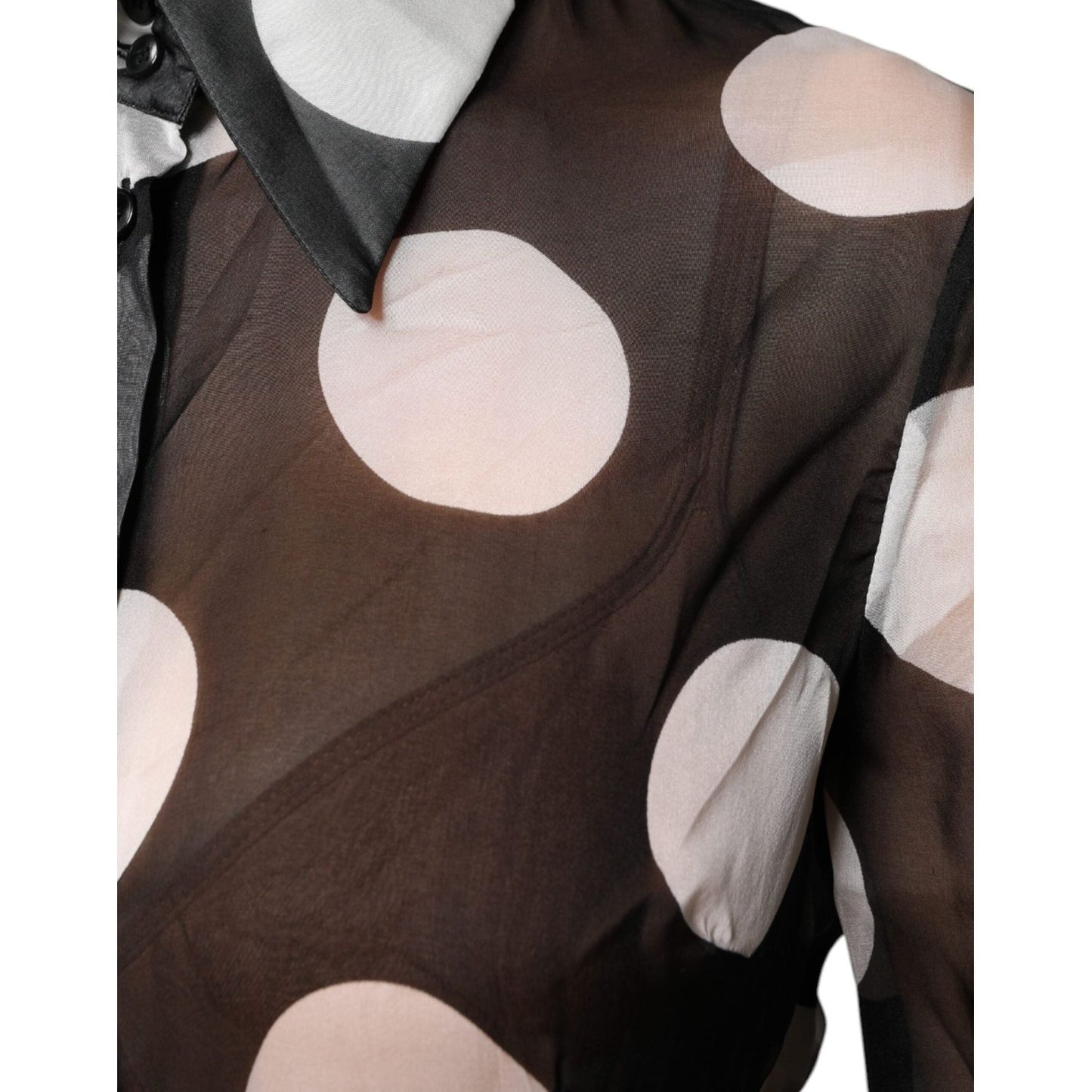 Dolce & Gabbana black and white polka dot silk top with long sleeves and collared design, featuring button front closure.
