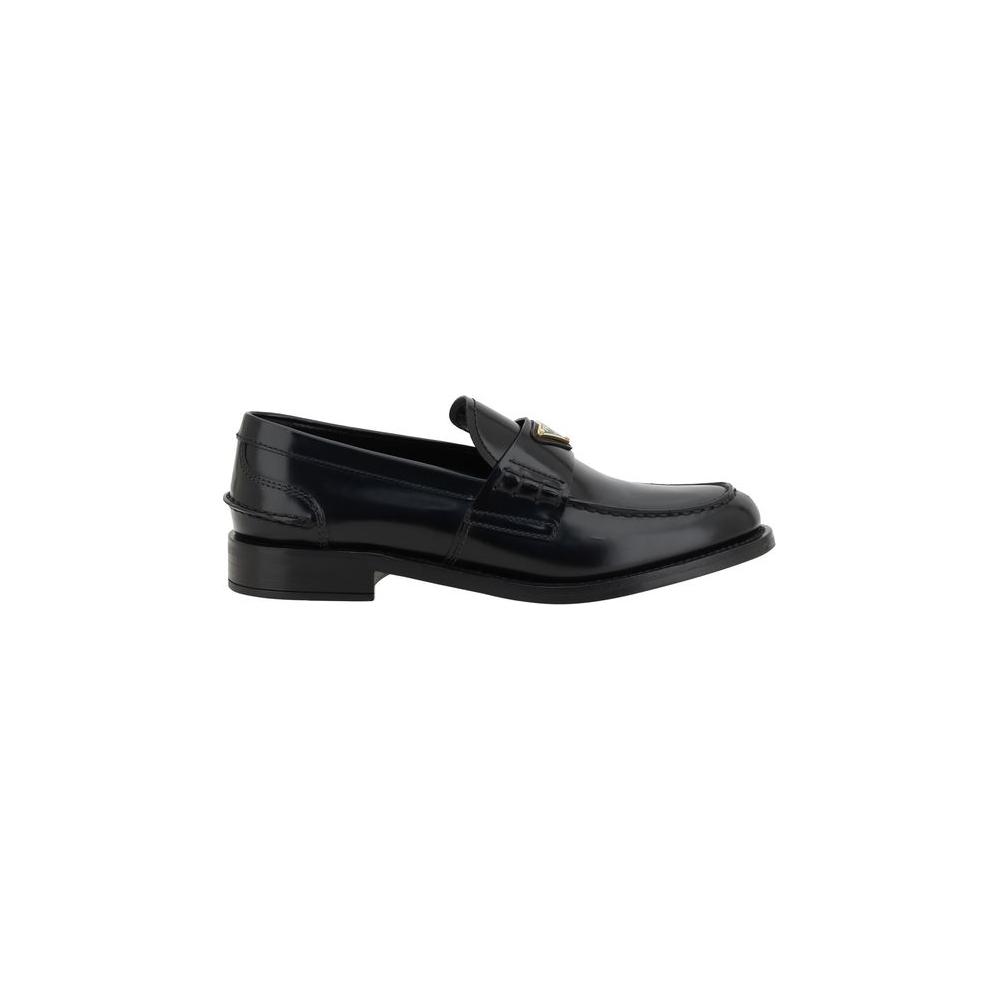 Prada Logo Loafers featuring leather design, elongated round toe, block heel, and iconic enameled plaque for a sophisticated look.