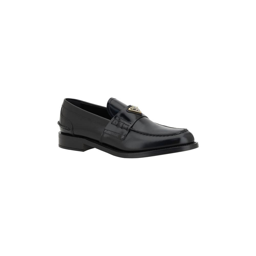 Prada Logo Loafers with leather block heel and iconic triangular plaque, offering classic elegance and comfortable style.