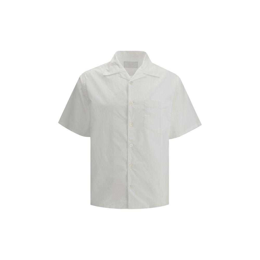 Prada short-sleeved cotton shirt with Cuban collar, front button closure, and tone-on-tone stripes, featuring a front patch pocket and side slits.