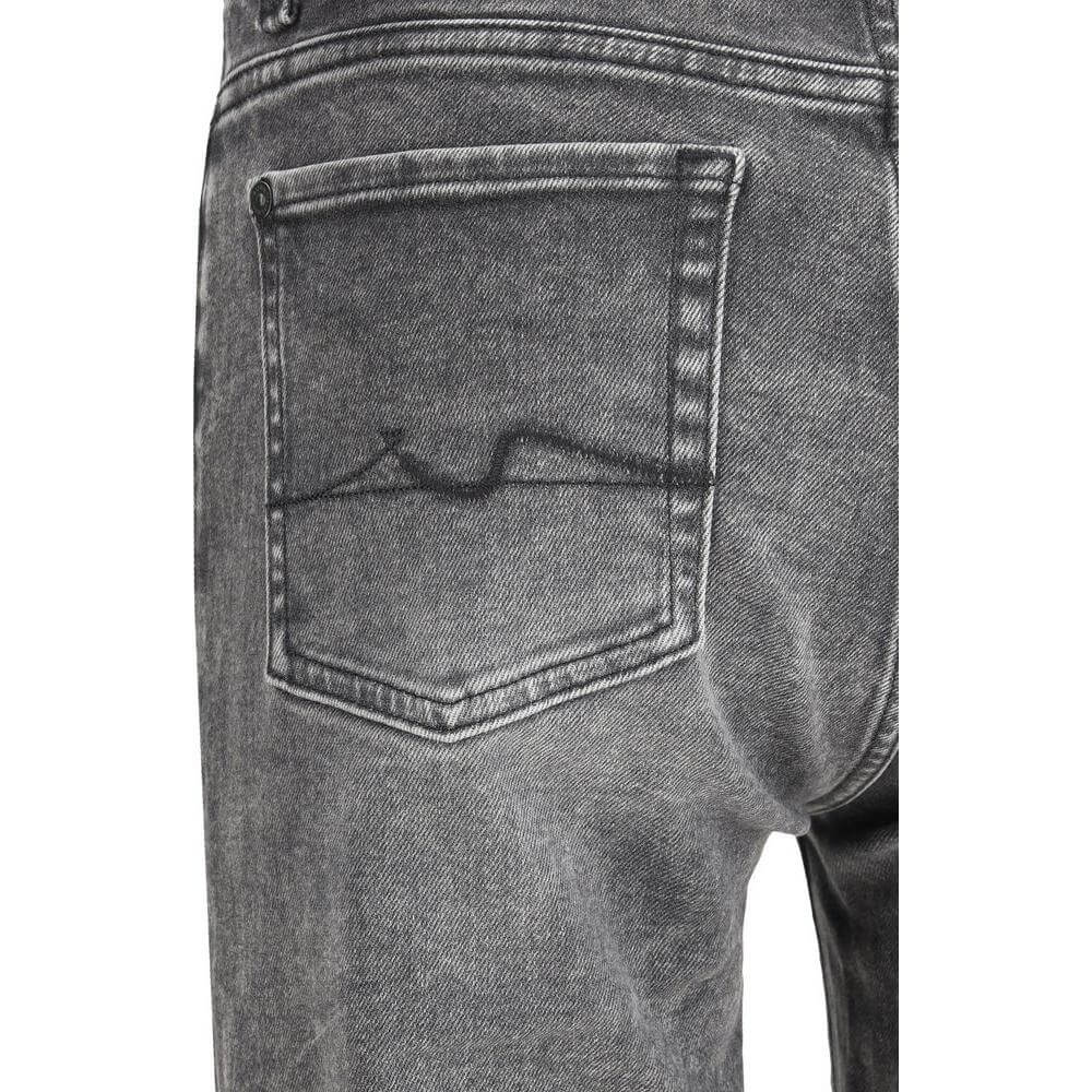 Close-up of 7For mid-rise cotton jeans with five-pocket style and leather patch detail on the back.