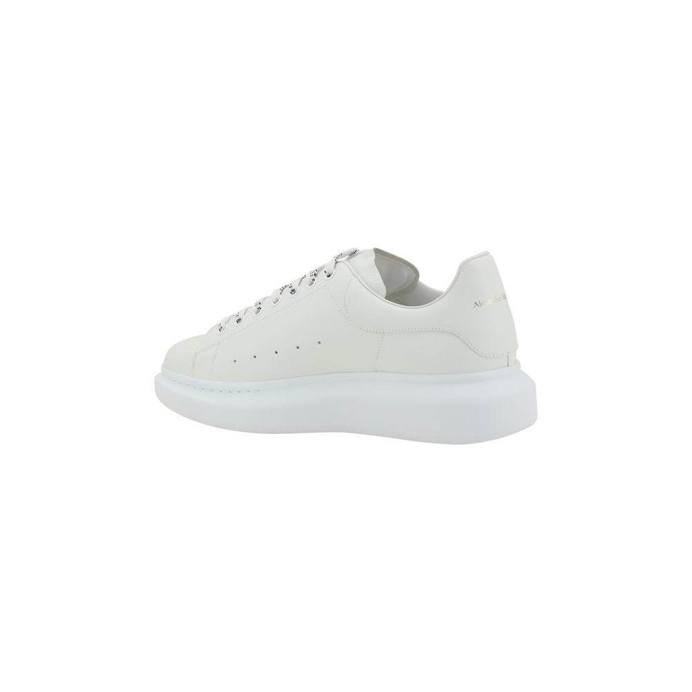 Alexander McQueen white leather sneakers with platform sole and logoed heel label, side view.