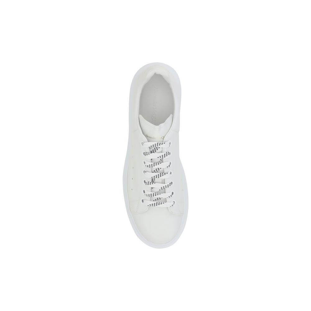 Top view of Alexander McQueen leather sneakers with lace-up front and platform sole, showcasing logoed heel label and round toe design.