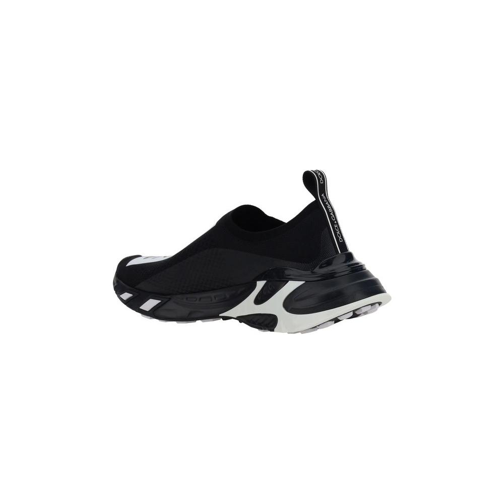 Dolce & Gabbana slip-on sneakers, featuring a textured panel sole and contrasting logo label, viewed from the side in black and white.