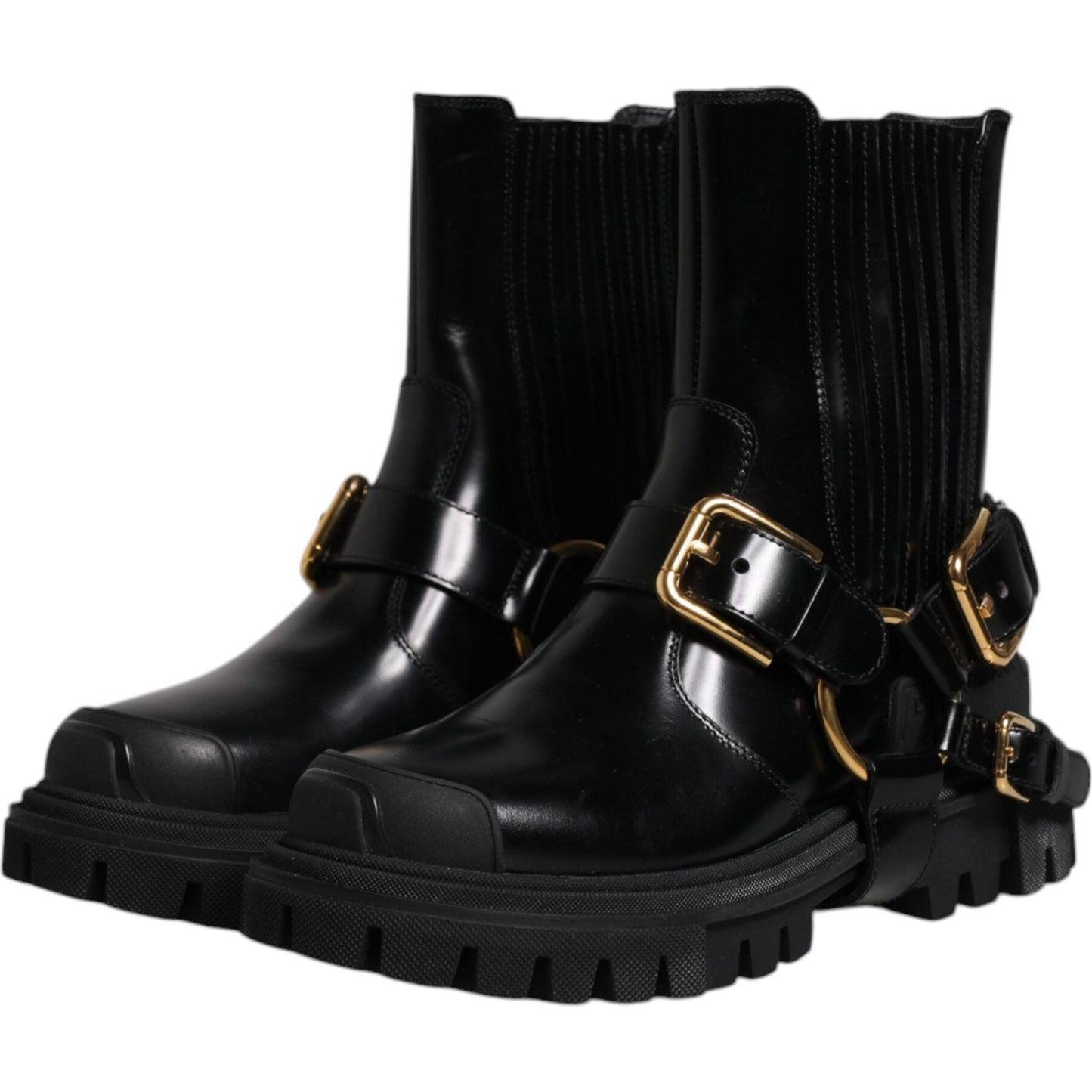 Dolce & Gabbana black leather slip-on mid-calf trekking boots with gold detail and rubber sole.