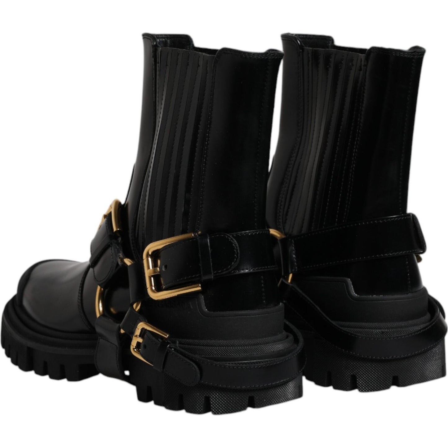 Dolce & Gabbana black leather slip-on trekking boots with gold detailing, rubber sole, minor scratches, exclusive Italian craftsmanship.