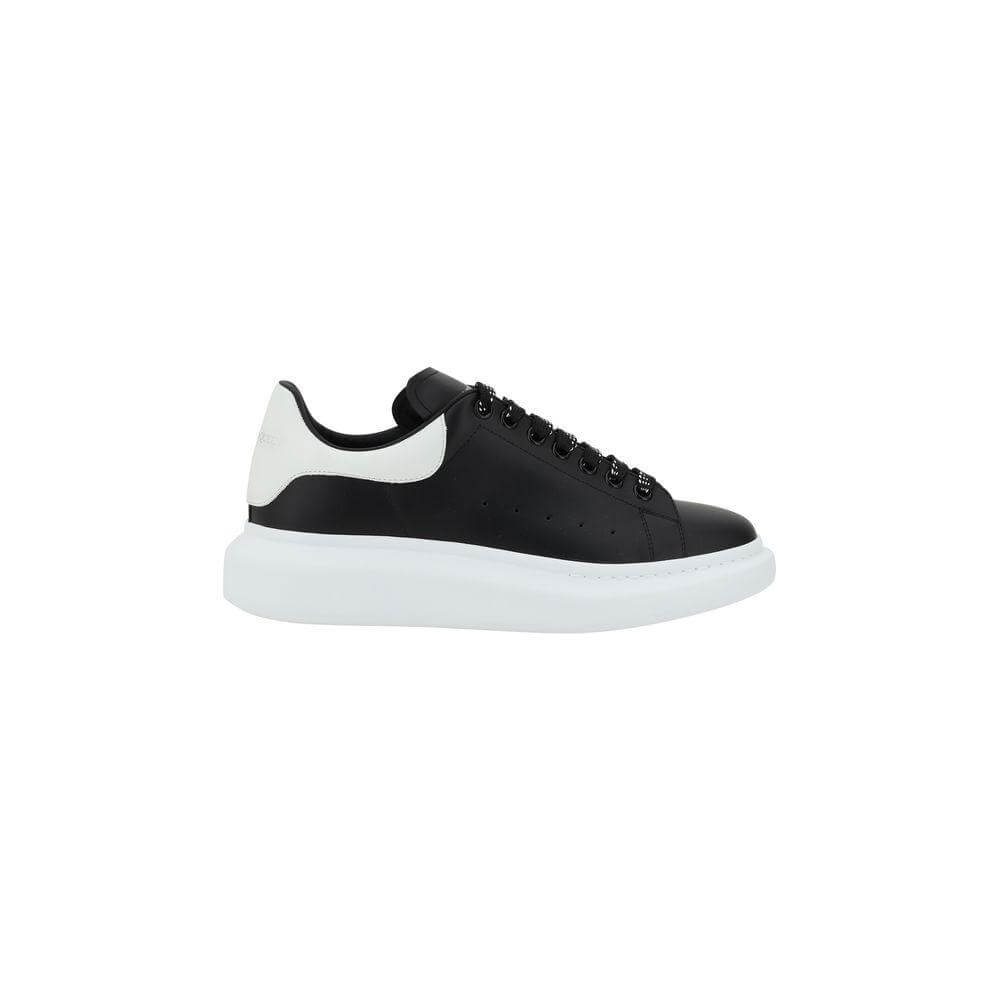 Black and white Alexander McQueen leather sneakers with lace-up closure, round toe, and platform sole for a bold, contemporary look.