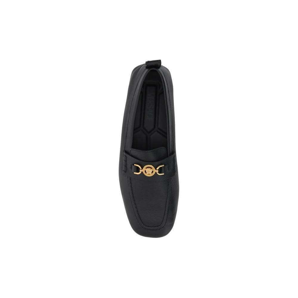 Versace driver loafer in black leather with metallic Medusa head, Greca motif on back, and hammered finish.